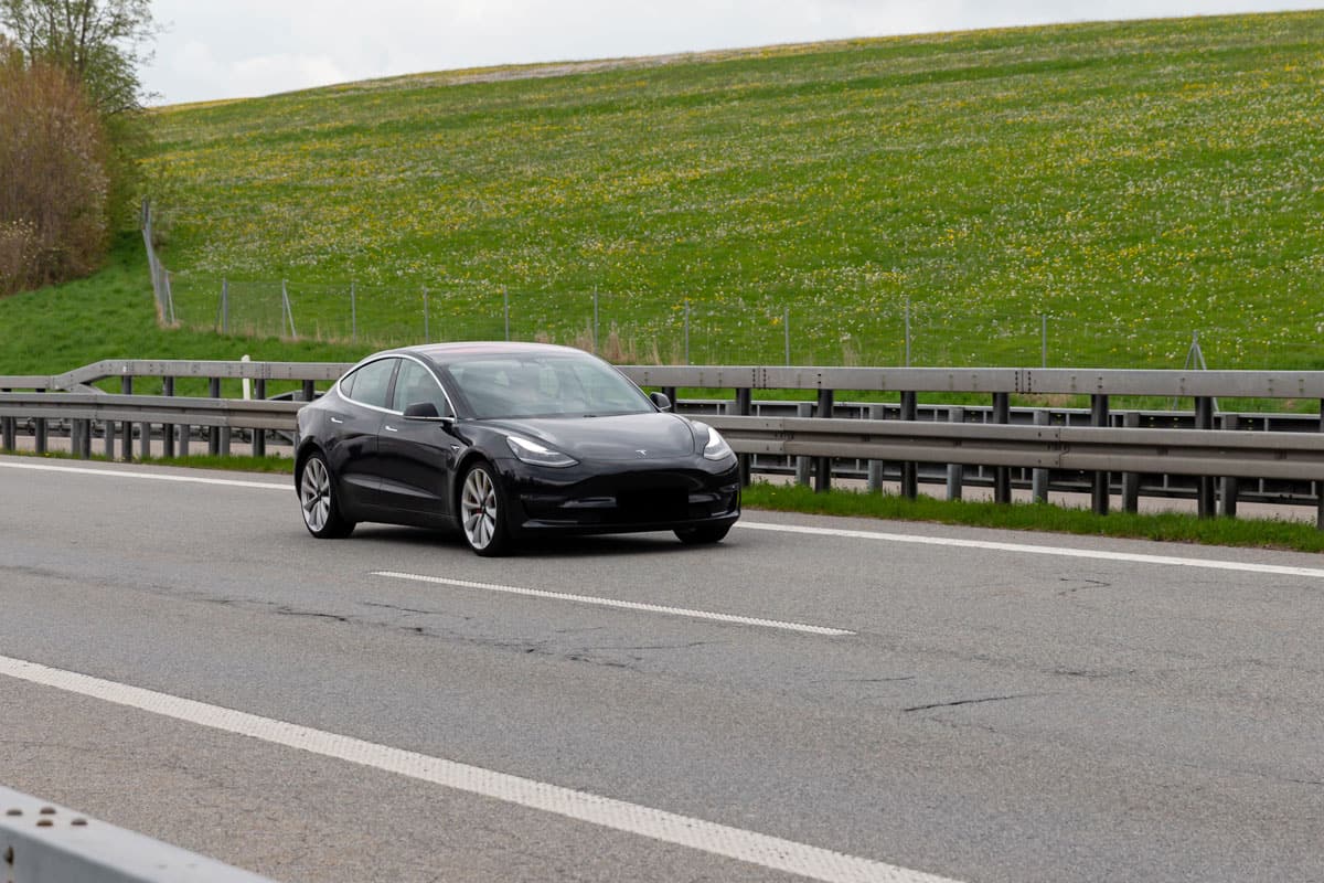 Tesla Model 3 cruising down the highway