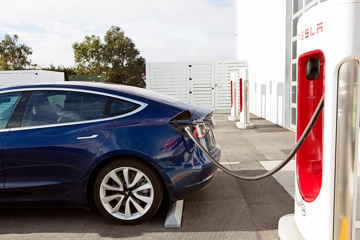 Tesla model 3 charging at supercharger station