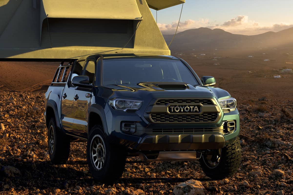 Toyota Tacoma equipped with a camping tent in mountainous