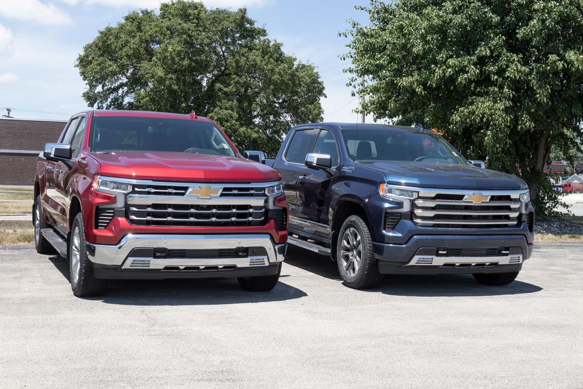 Two high end Chevrolet Silverados at a parking lot
