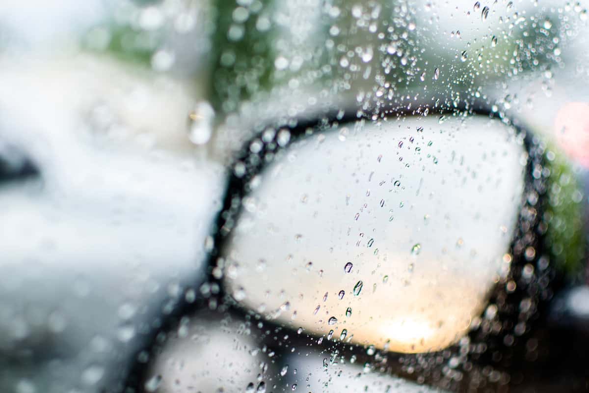 side mirror of the car mobolism in the rain. drops, glass