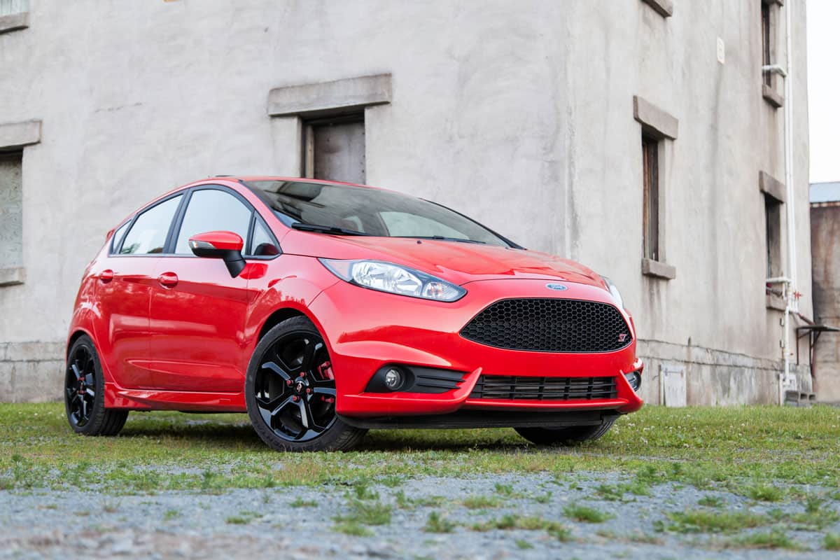 A Ford Fiesta ST parked in front of an abandoned building