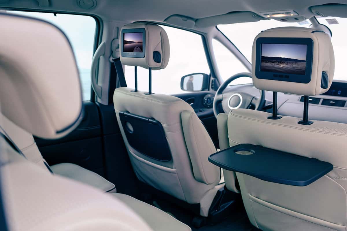 A Modern interior of the Backseats of A Car With Installes Monitors Showing Photos of the Sea