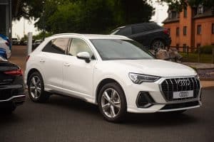 A new Audi Q5 SUV on the forecourt at an Audi dealership. The current version of the Q5 has been in production since 2016. - How Many Miles Can An Audi Last [Breakdown By Model]