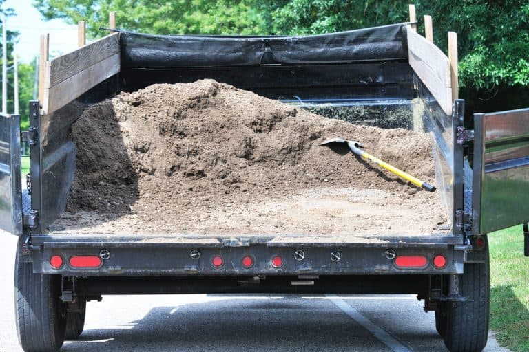 A dump trailer carrying dirt, Does My Truck Charge My Dump Trailer Battery?