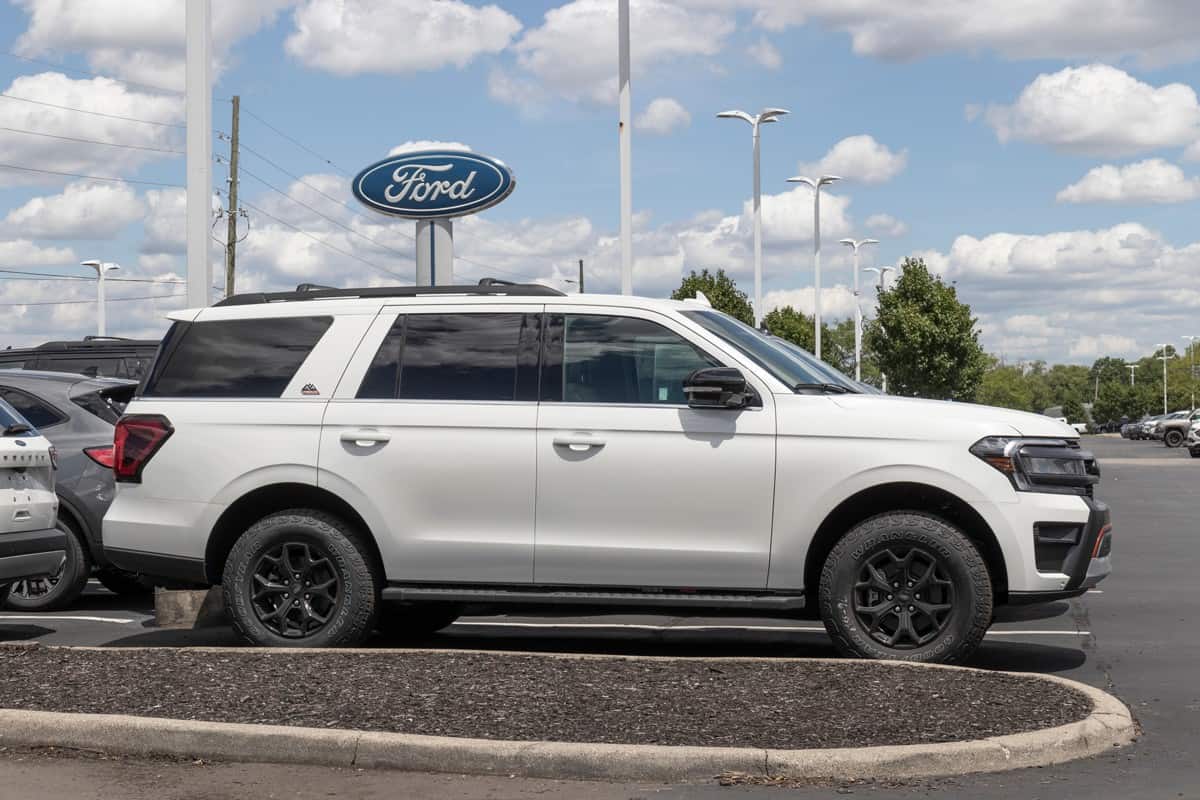 A white Ford Expedition at a Ford dealership