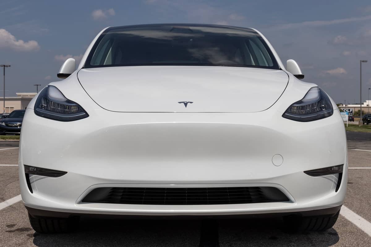 A white Tesla Model 3 at parking lot