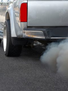 Air pollution from diesel vehicle exhaust pipe on road, Truck Smells Like Burnt Popcorn - Why And What To Do?