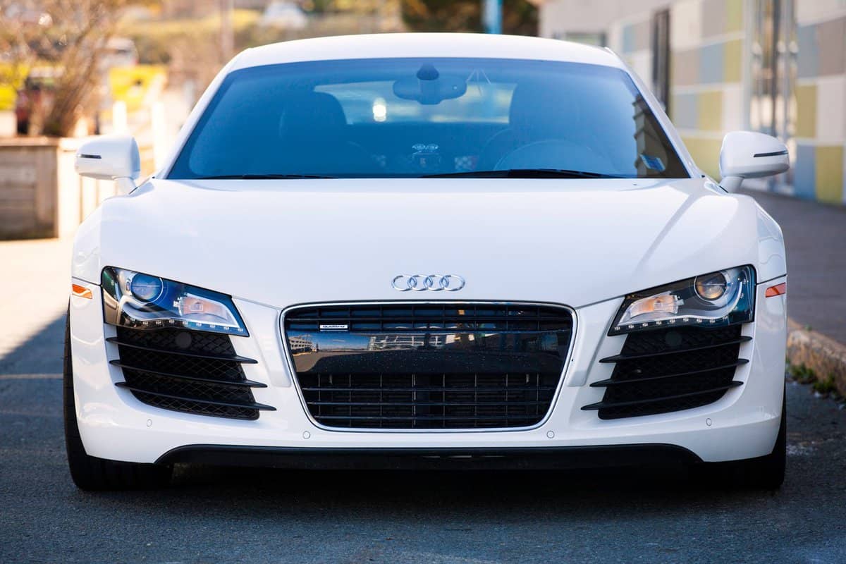 An Audi R8 front view showing the Audi emblem in center of hood, and the world's first, all-LED headlights.