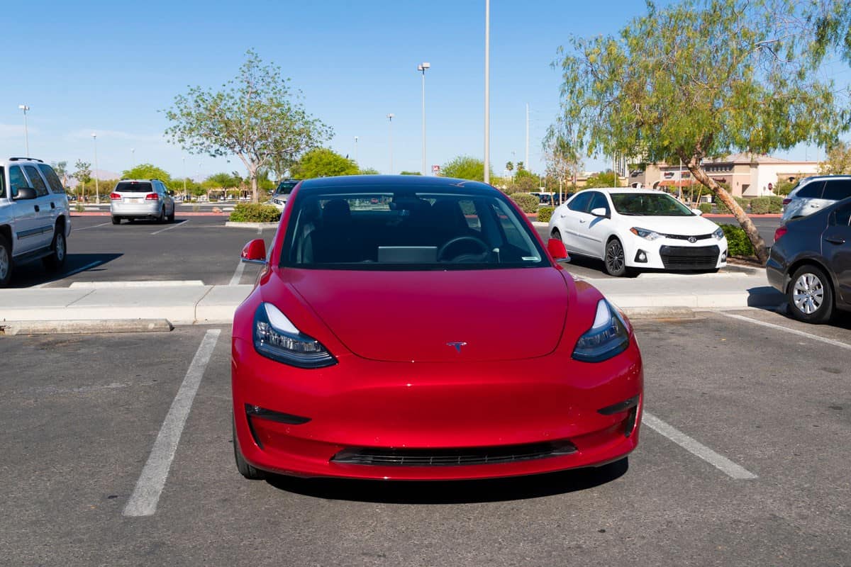 An editorial stock photo of a Tesla Model 3 parked in a parking lot in Las Vegas