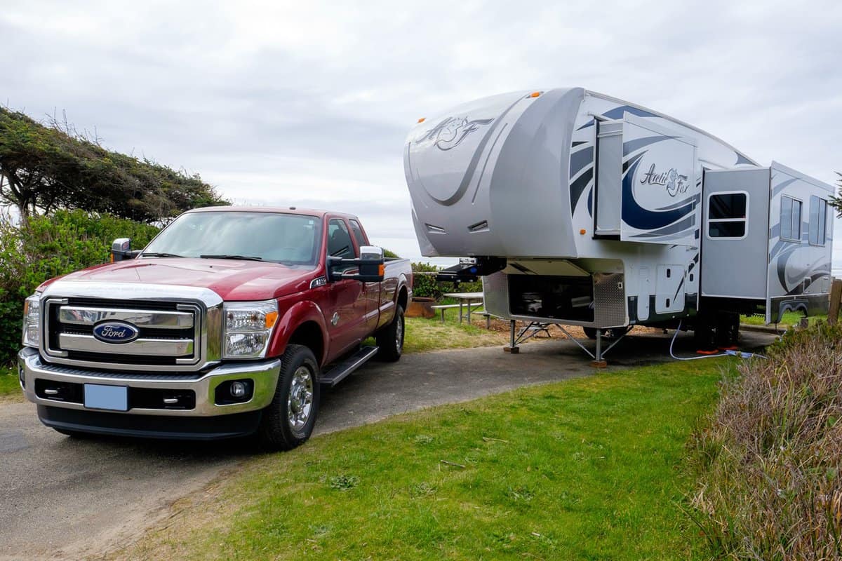 Campsite with a large Arctic Fox 5th Wheel and a Ford F350 truck.