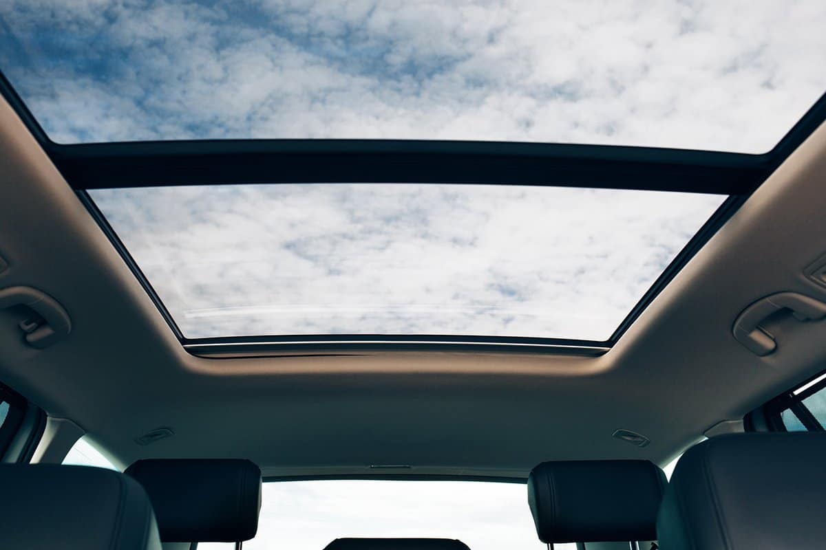Clean sunroof and view at the sky from the inside or car interior