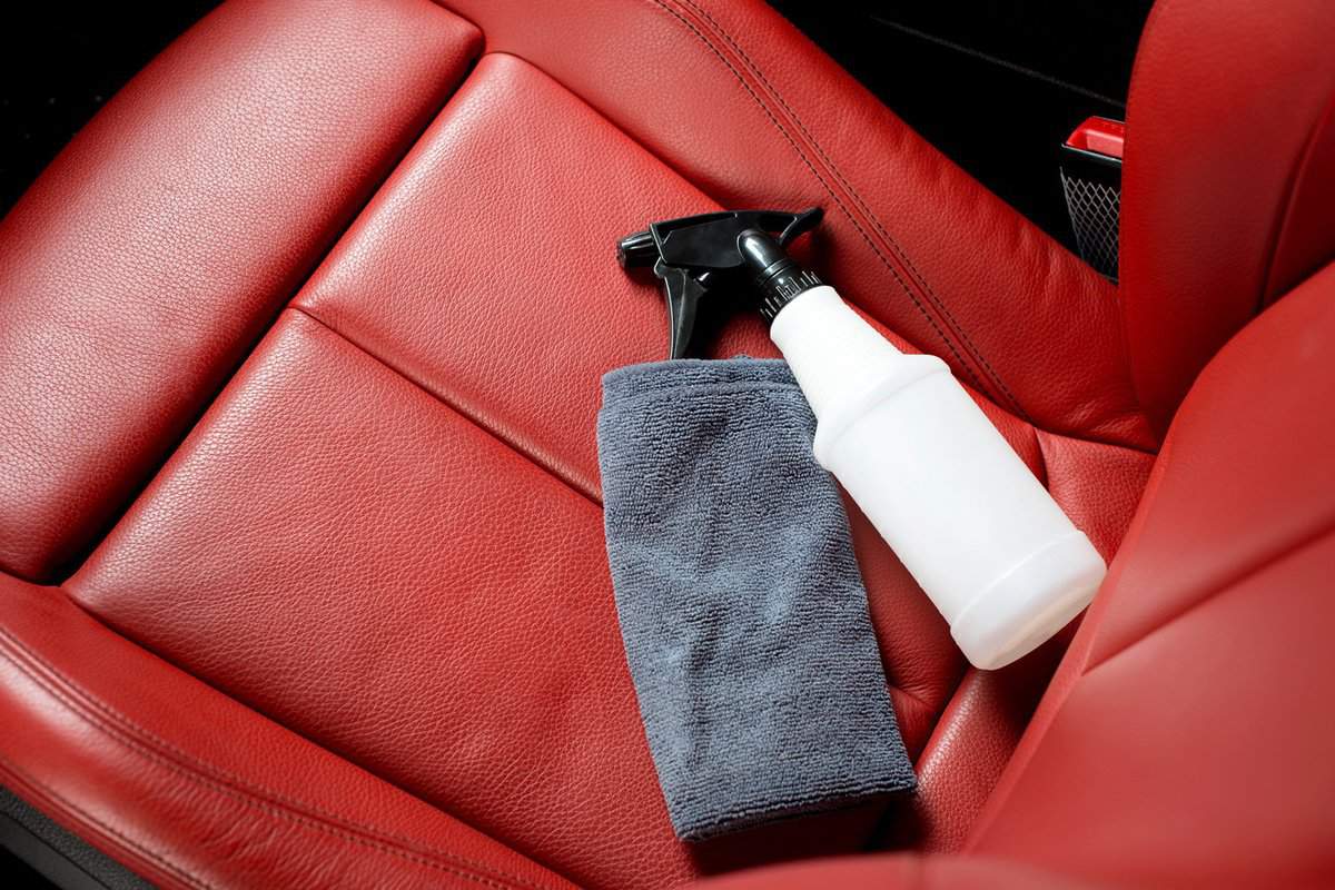 Detailing series, Chemical bottle and micro fiber cloth on leather seat.
