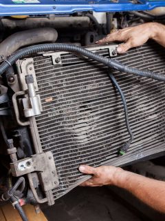 Disassembly of an old and worn car radiator by a mechanic, Does Evacuating Car AC Remove Oil?