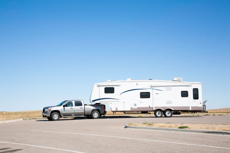 Large white RV trailer hitched to a double cab gray truck, Is My Truck Too Tall For A Fifth Wheel?