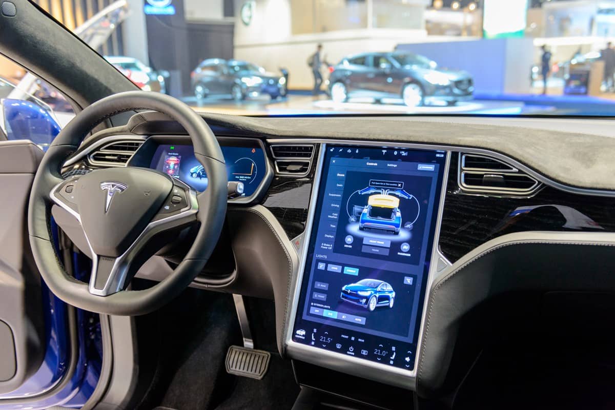 Luxurious interior on a Tesla Model X 90D full electric luxury crossover SUV car with a large touch screen and dashboard screen