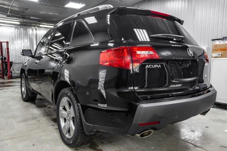 Rear view of used Acura MDX 2008 year black color with red taillamps standing in the light service box of the detailing workshop after polish and washing. - Acura ILX Won't Start And Says Check Brake System - Why And What To Do?