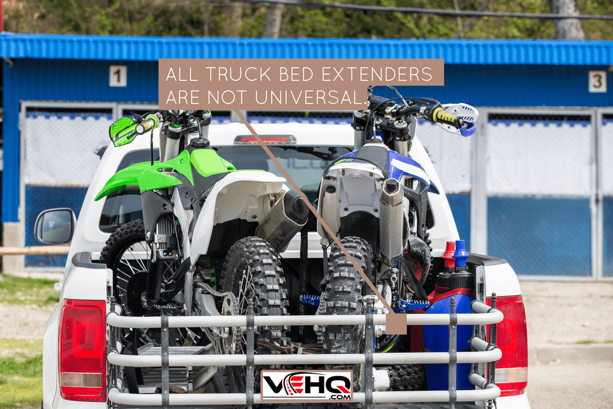 Rear viwe with two dirt bike motorcycles on the back of the truck with safety gear in residential setting - Are Truck Bed Extenders Universal