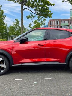 Red Second-generation Nissan Juke parked on a public parking lot, What Is The Best Oil For Nissan Juke?