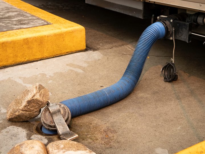 Sewer hose connecting RV holding tank to RV dump station hole, Can I Put Vinegar In My Black Water Tank?