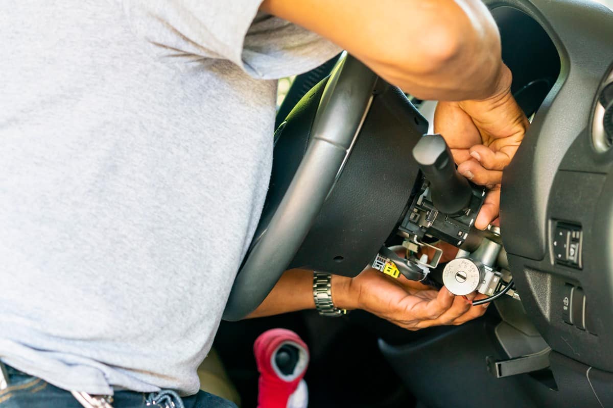 Technician checking the ignition switch of a car
