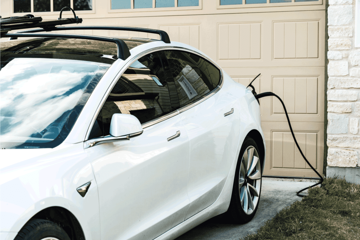 Tesla Model 3 charging at home in front of the house
