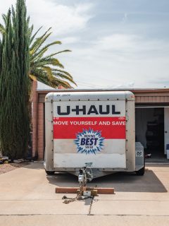 U-haul moving trailer parked in front of a residence., How To Remove U-Haul Hitch From Car