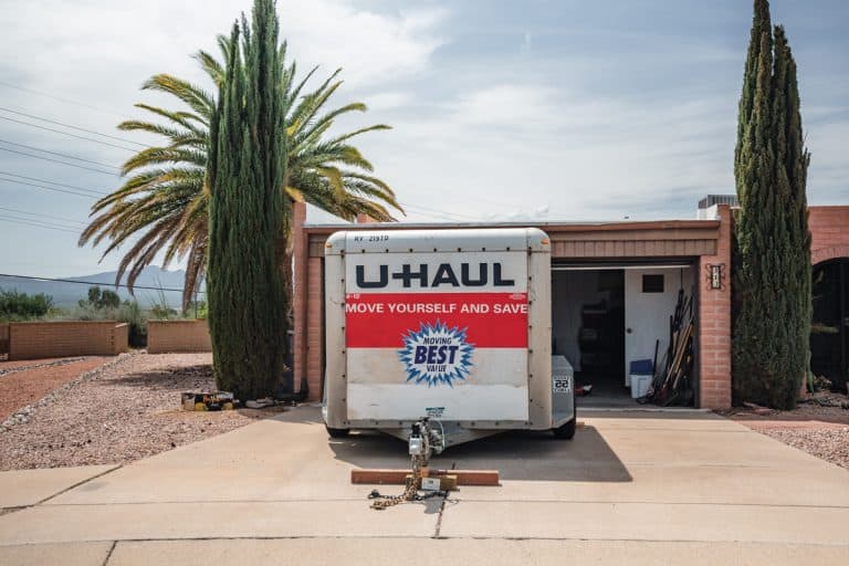 U-haul moving trailer parked in front of a residence., How To Remove U-Haul Hitch From Car