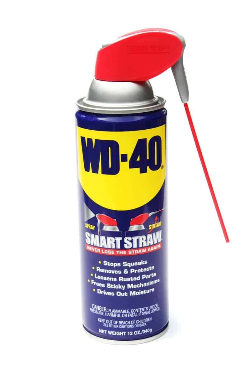 WD 40 with a straw on a white background