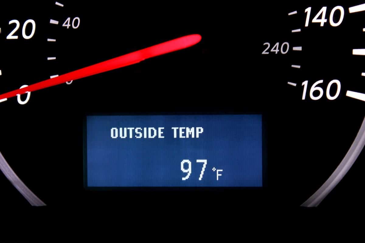 close up photo of a car ambient temperature on dash board speedometer