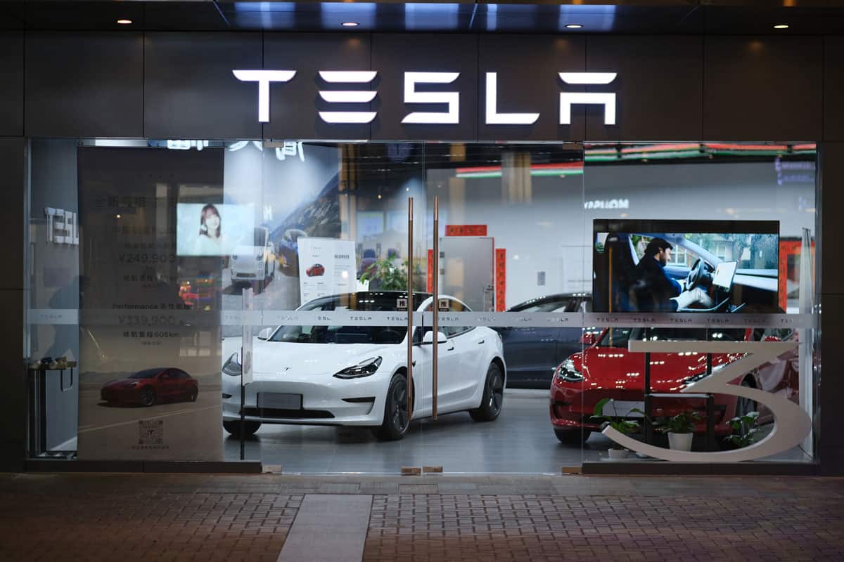 facade of Tesla store at night, American electric car brand