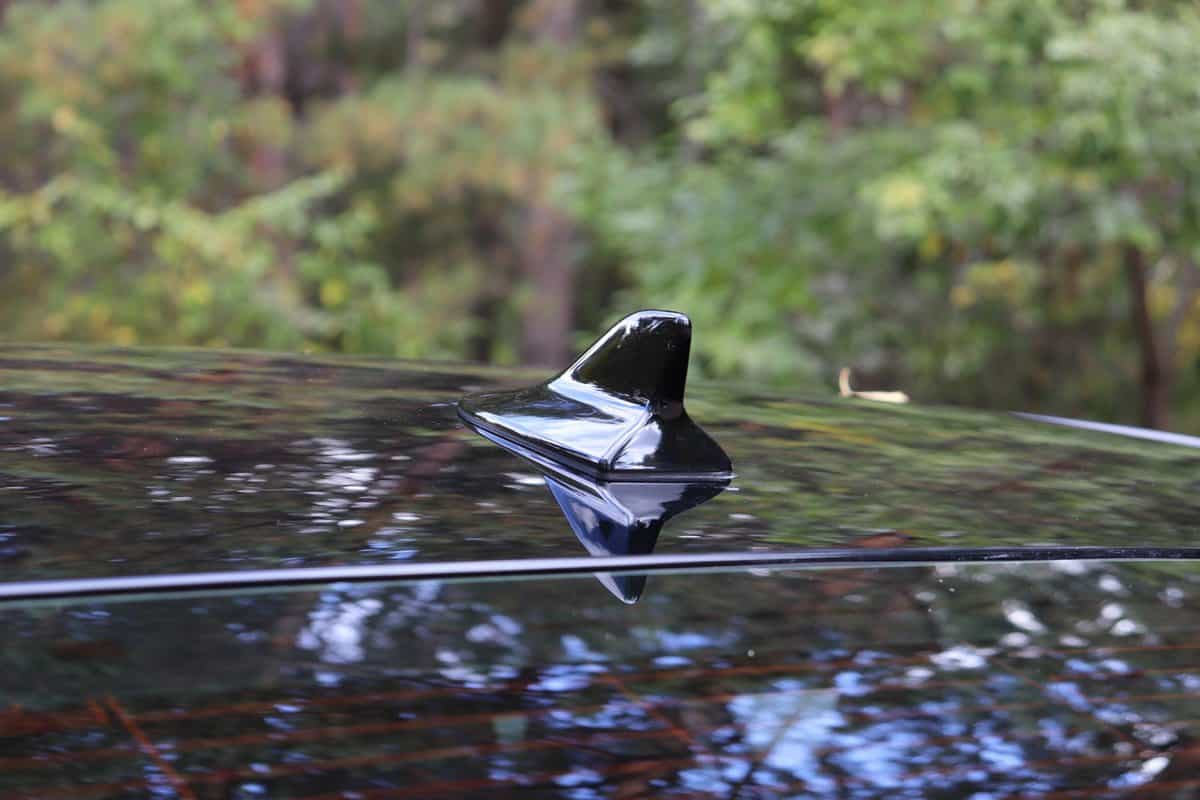 gps antenna shark fin shape on a roof of car for radio navigation system