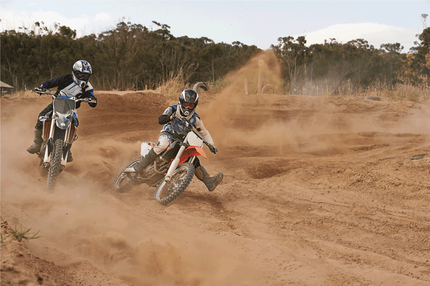 two men in competition using their dirtbikes