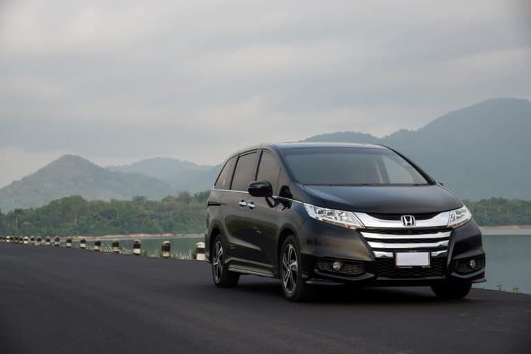 A black colored Honda Odyssey moving down the road, How To Watch Netflix In Honda Odyssey