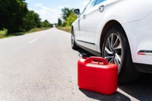 A car parked on the side of the road, an empty red canister. Selective focus, noise. The driver is on the road. Help on the road. Fuel shortage - oil, diesel, gasoline, petrol. - How To Put Gas In A Car Without Funnel