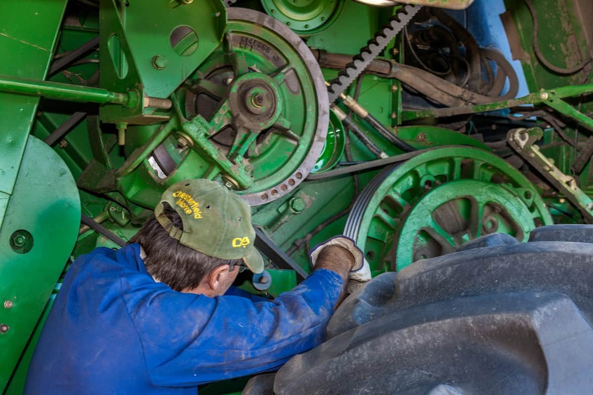 A farmer performs routine maintenance on a combine harvester in Moree, a major agricultural area in New South Wales, Australia.
