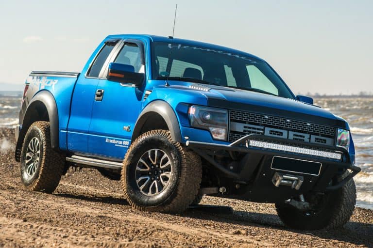 A huge blue colored Ford F150 trekking at a dirt road, Ford F-150 Catalytic Converter Scrap Price - How Much Can You Expect?