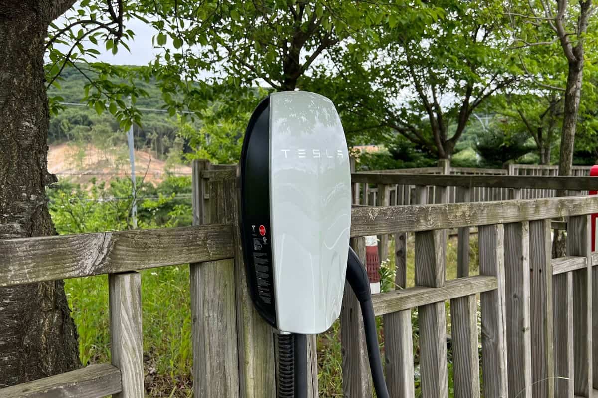 A small white Tesla charging station