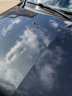Car engine hood with many hail damage dents show the forces of nature and the importance of car insurance and a replacement value i, How To Remove Acorn Dents From My Car?