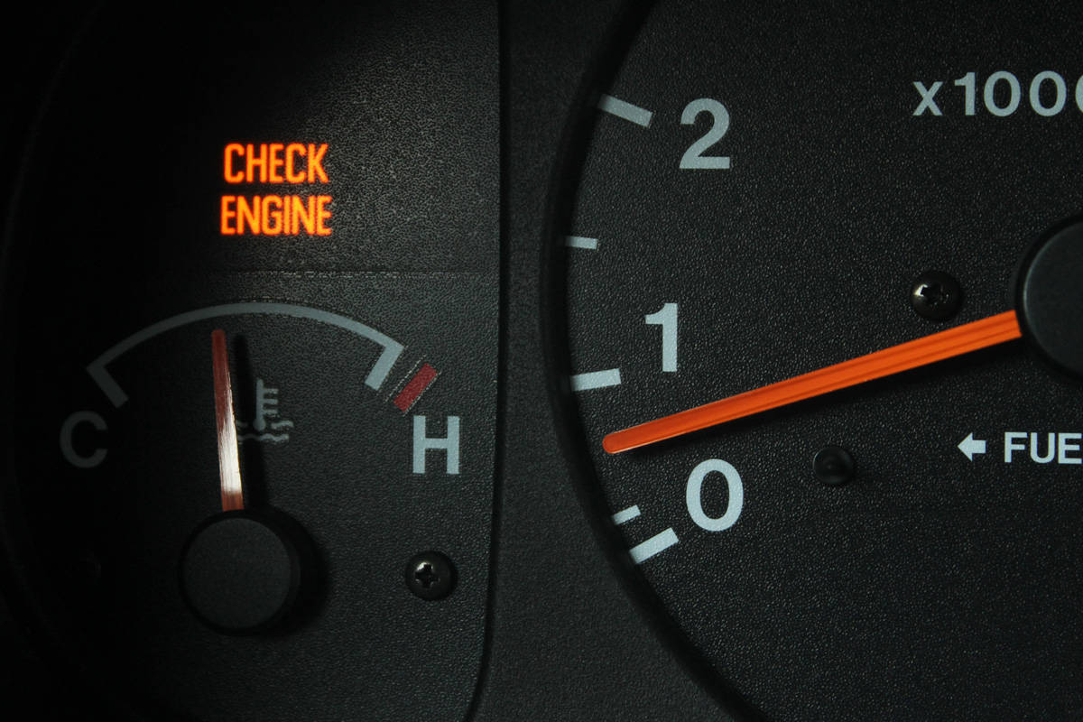 Check engine light glowing in car dashboard
