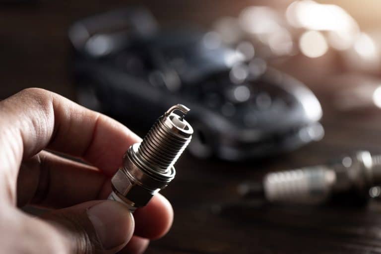 Close up new automotive spark plug. Car maintenance concept. - How To Close The Gap On A Spark Plug