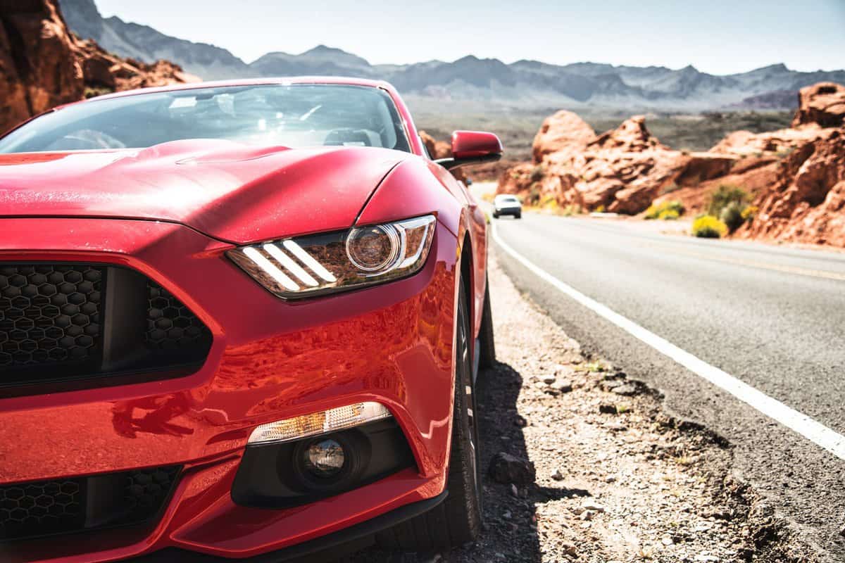  Front view of a red Ford Mustang GT parked along the road of the Valley of Fire Highway in the Valley of Fire park. Ford Mustang is a sport muscle car made in US by Ford