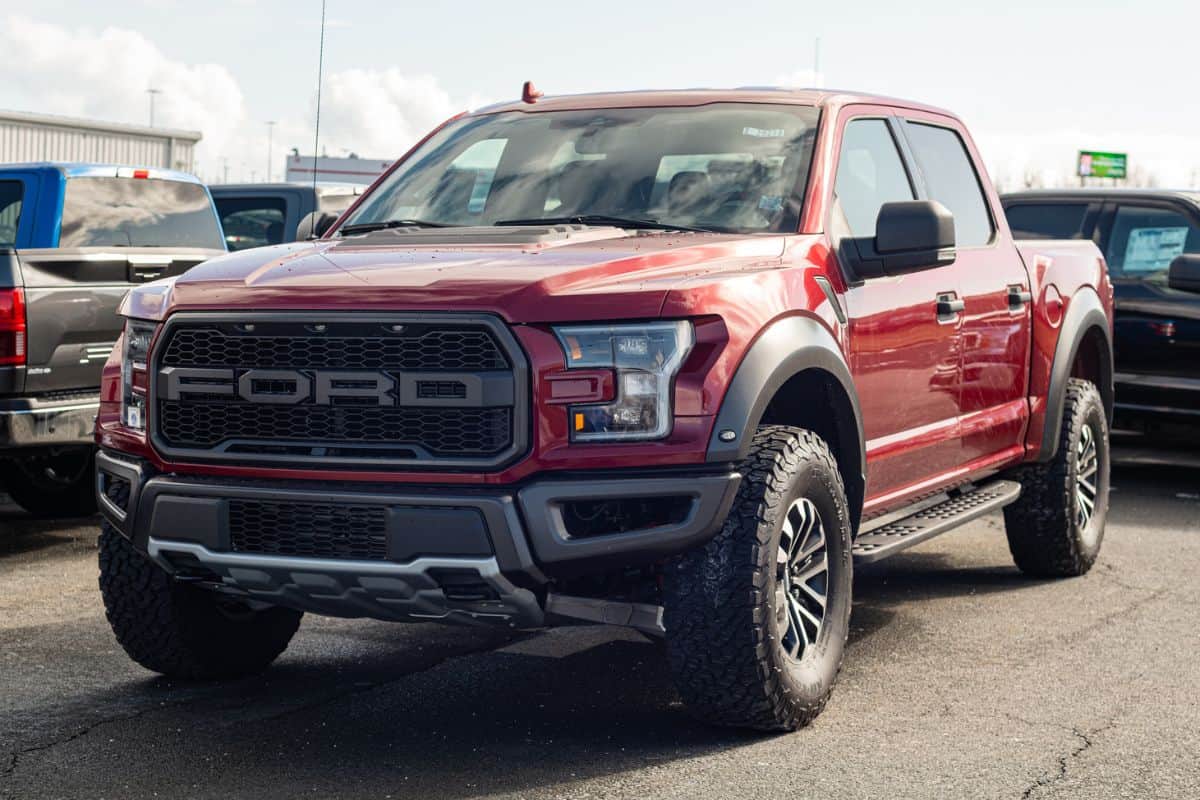 Ford F-150 Raptor pickup truck at a Ford dealership.