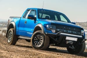Ford F150 Raptor SUV is on the road driving on dirt . pickup, F150 Won't Start But The Lights Are Flashing - What Could Be Wrong?