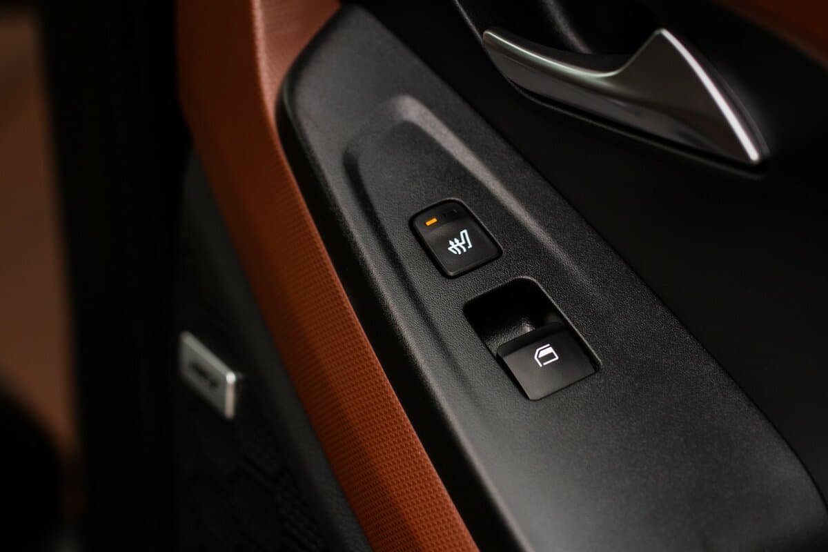 Seat heating controller buttons close up view. Car interior. Seat heater button, car interior. Heating mode is weak.