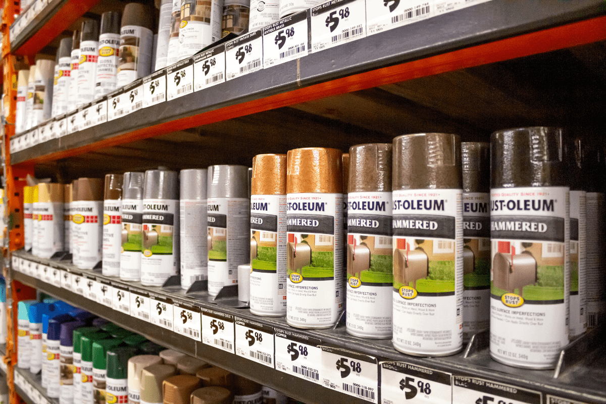 Several cans of Rust-Oleum protective paints on a shelf at a local home improvement store