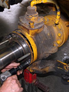 Shows mechanic using air tool to secure spindle to axle housing on on heavy all wheel drive truck, steering knuckle - Axle Not Going In - Why And How To Push It In All The Way