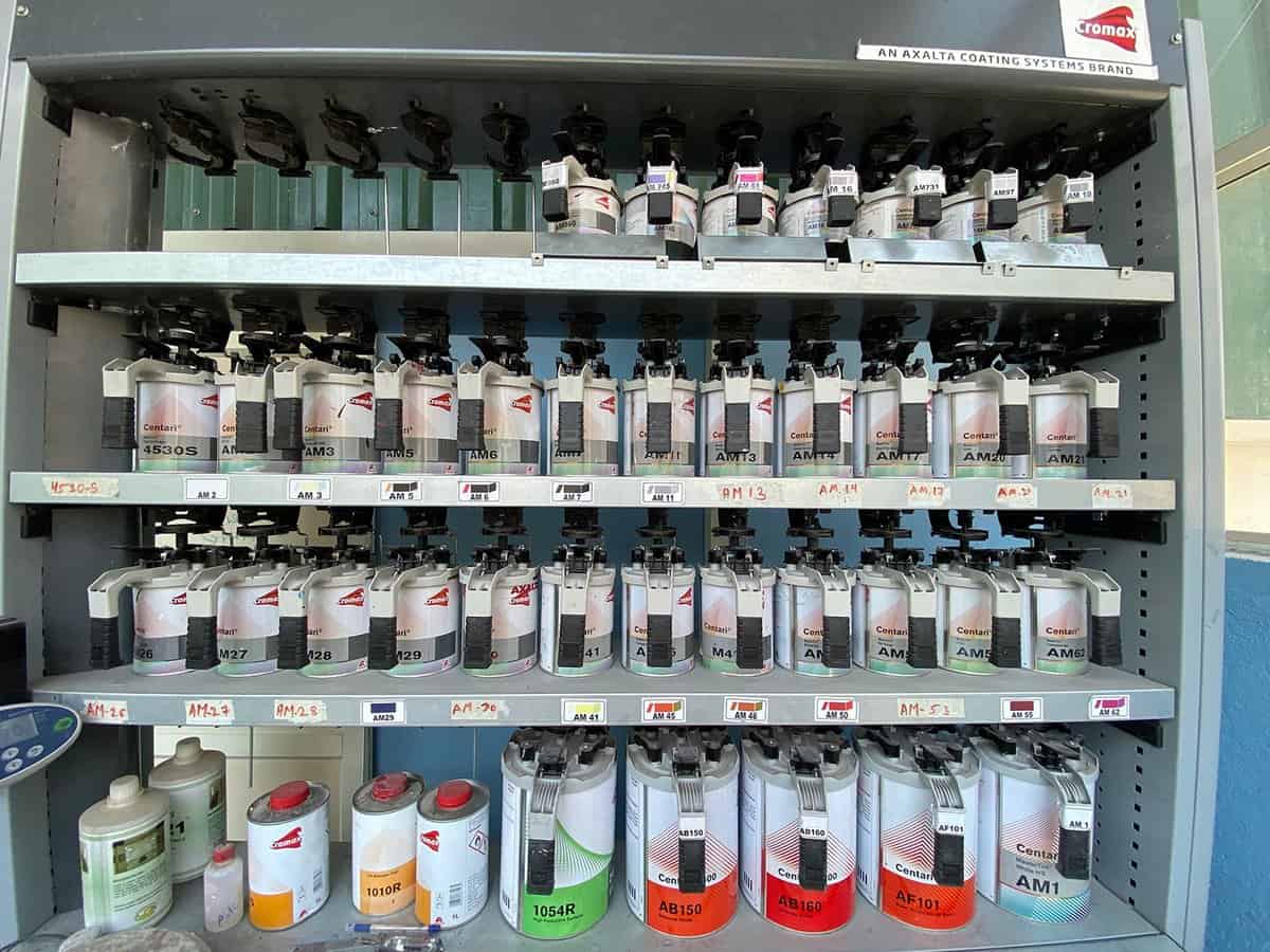 Stand with different paints in a bodyshop of car repair station