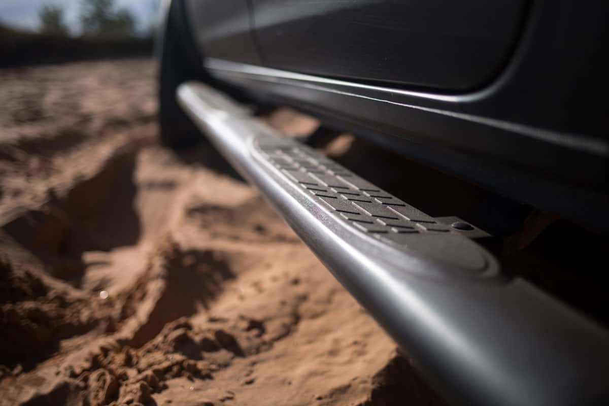 Suv car stuck in sands off road during expedition focused on running boards