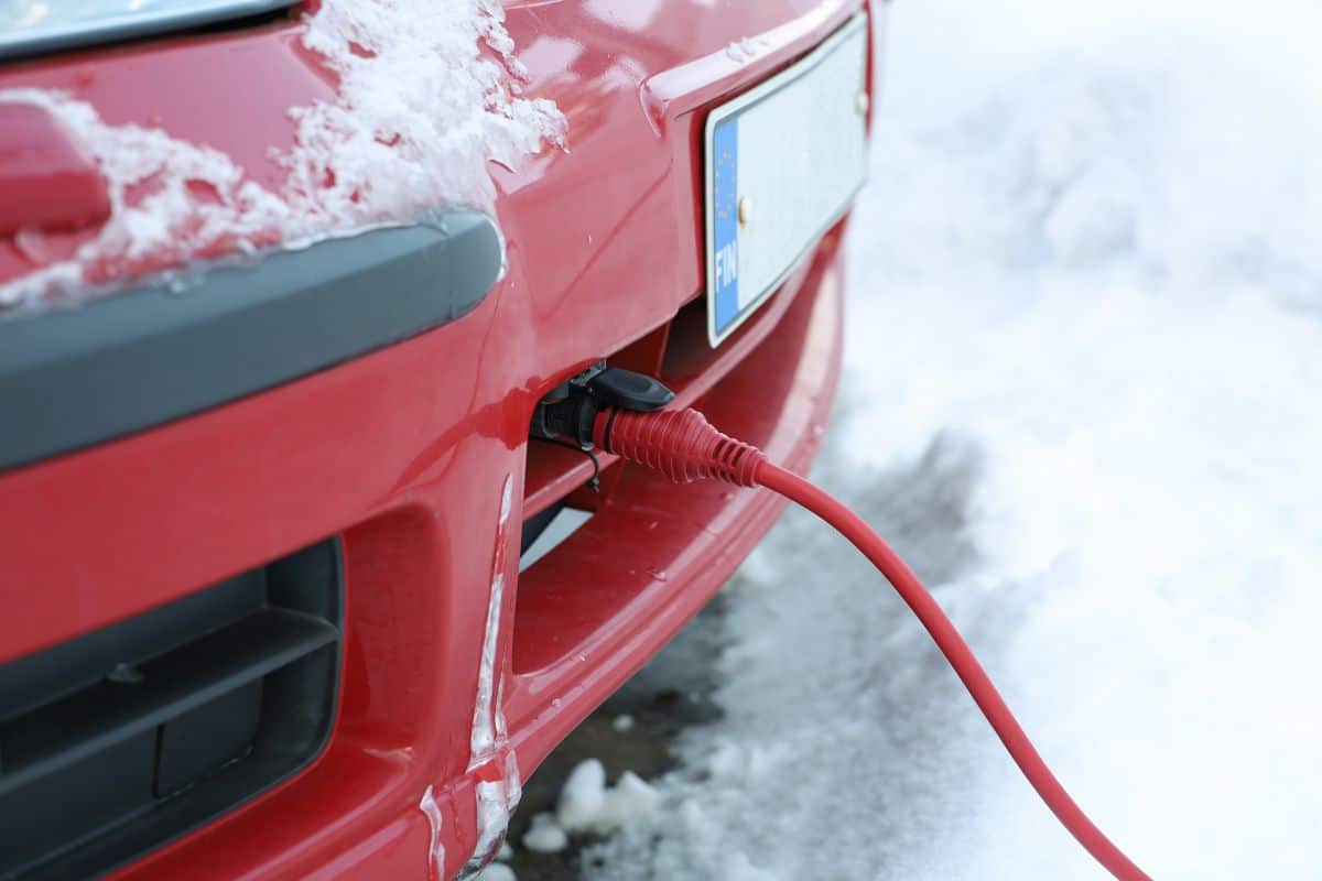 The power cord of the block heater connected to the car engine in winter